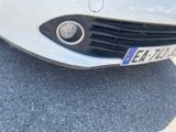 a white car parked on the side of the road