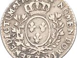 a silver coin with a crown on top of it