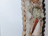 a mirror made out of shells on the wall