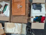 many boxes of clothes and other items that are on the floor