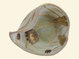a picture of a shell with a bird and flowers on it