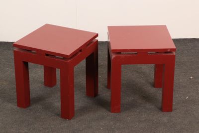 two red tables sitting next to each other on the floor