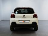 the rear of a white citrole parked in a white room