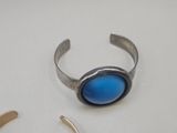 a silver ring with a blue stone on it