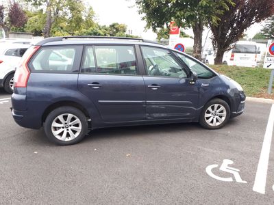a small blue car parked in a parking lot