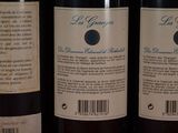 three bottles of wine sitting on top of a table next to each other