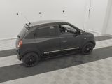 the small black car is parked in the garage on the checkered floor