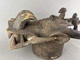 an image of a wooden sculpture of a dragon head