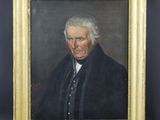 a portrait of a man in a black coat and white hair