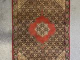 two rugs hanging on the wall next to each other