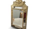 a mirror that is sitting on the floor in front of a bed