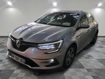 a grey car is parked in a large room with checkered floor