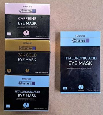 two boxes of masks are sitting on a table next to each other