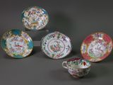 four different types of china plates and cups on a gray surface