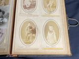 an old book with pictures of children on it sitting on a table