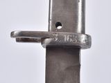 a close up of a knife on a white surface