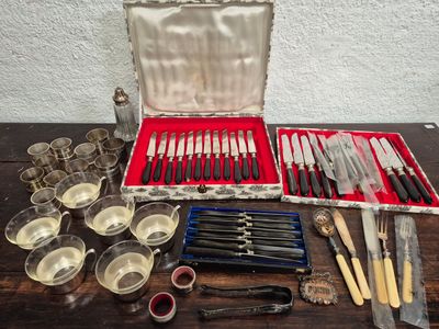 many different types of knives and spoons in a case