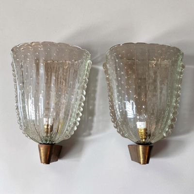 two glass vases that are on the wall