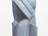 a gray sculpture on a white pedestal on a white surface