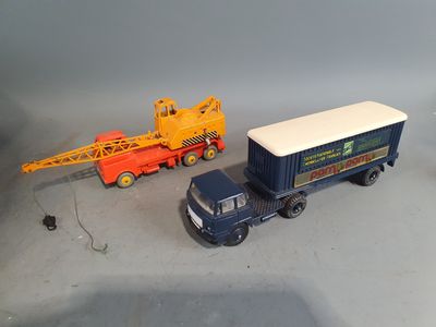 a toy truck with a crane on the back of it