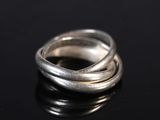 a close up of a silver ring on a black surface
