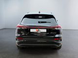 the rear end of a black suv parked in a white room