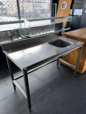 a stainless steel sink and a counter in a kitchen