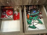 two open drawers with tools in them on a table