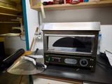 a toaster oven sitting on top of a counter in a kitchen