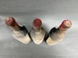 three bottles of wine sitting next to each other on a table