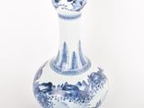 a blue and white vase sitting on a white surface
