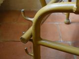 a yellow chair that is sitting on a brick floor