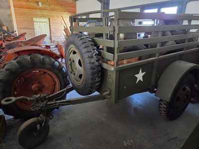 a truck with a star on the back and a tractor in the back