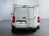 the back of a white van with a ladder on the back of it