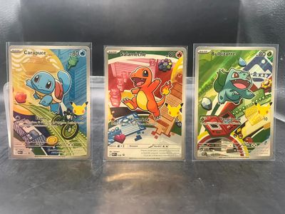 Trois cartes à collectionner Pokémon sont posées sur une table