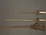 three different types of weapons are displayed on a gray surface
