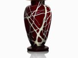 a red vase with a white and black design on it