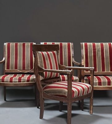 three chairs with striped upholstered cushions and a wooden arm rest