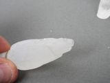 a person holding a piece of ice in their hand