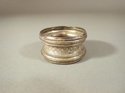 a silver ring sitting on top of a table