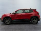 the red suv is parked in a parking lot on a cloudy day