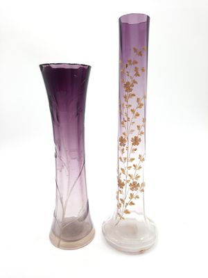 two purple vases sitting next to each other on a white surface