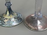 two glass vases sitting next to each other on a table