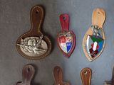 many different types of leather luggage tags on the wall