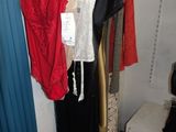 a lot of dresses hanging on a rack in a room