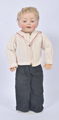 a small doll that is wearing a white shirt and black pants