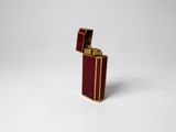 a close up of a red lighter on a white surface