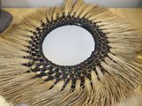 a picture of a straw sunburst on a wooden table