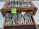 a lot of silverware on a table with a price tag