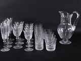 a lot of glasses and a pitcher on the table